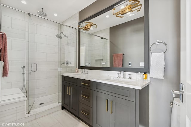 bathroom with a shower stall, double vanity, recessed lighting, and tile patterned floors