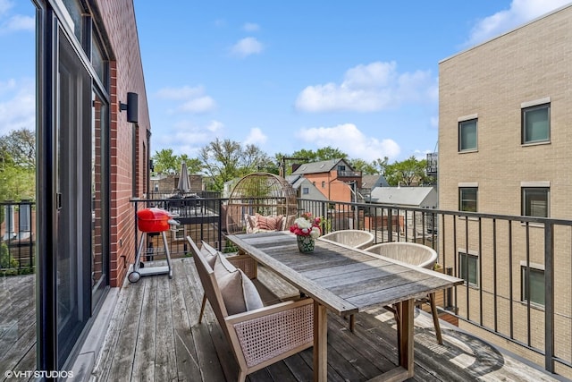 balcony with outdoor dining space and a residential view