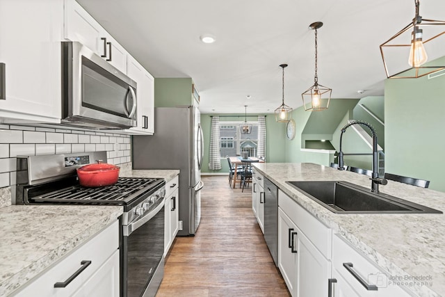 824 Briar Glen Ct, Hampshire, IL 60140 - kitchen with stainless steel appliances, a sink, light wood-style flooring, white cabinetry, and recessed lighting
