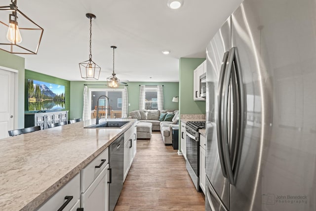 824 Briar Glen Ct, Hampshire, IL 60140 - kitchen featuring stainless steel appliances, a sink, white cabinets, decorative light fixtures, and recessed lighting