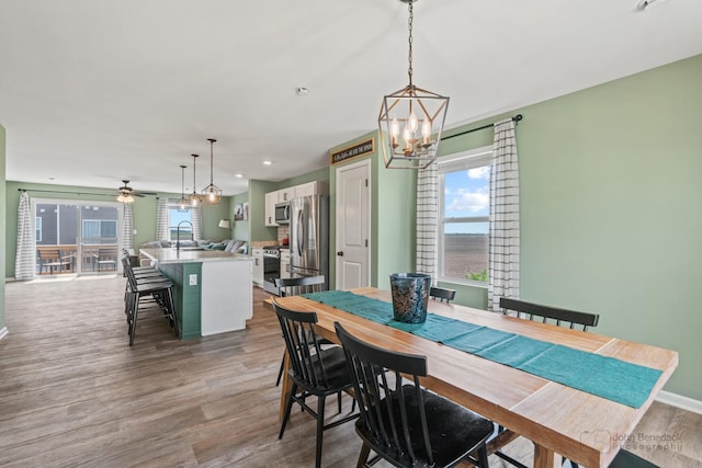 824 Briar Glen Ct, Hampshire, IL 60140 - dining space with wood finished floors, a chandelier, and baseboards