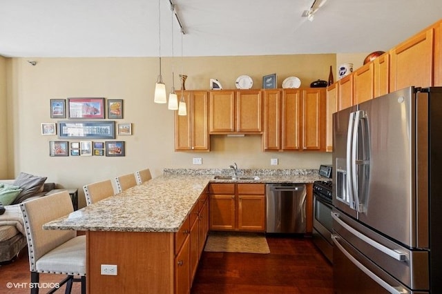 1464 S Michigan Ave Unit 703, Chicago, IL 60605 - kitchen featuring stainless steel appliances, rail lighting, a sink, and a breakfast bar