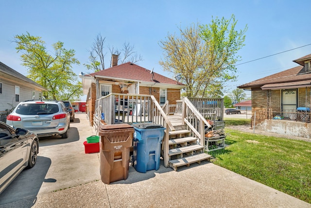103 Grandview Ave, Lockport, IL 60441 - view of front facade with brick siding, a chimney, and a wooden deck