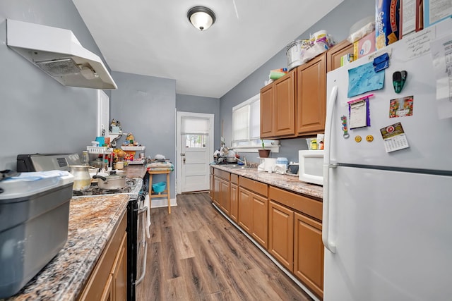 103 Grandview Ave, Lockport, IL 60441 - kitchen featuring white appliances, under cabinet range hood, wood finished floors, brown cabinetry, and a sink