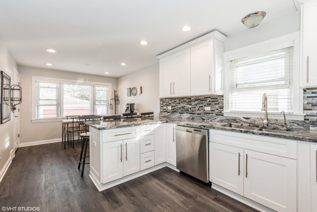 1080 E Prairie Ave, Des Plaines, IL 60016 - kitchen with dishwasher, a sink, a peninsula, white cabinets, and dark wood-type flooring