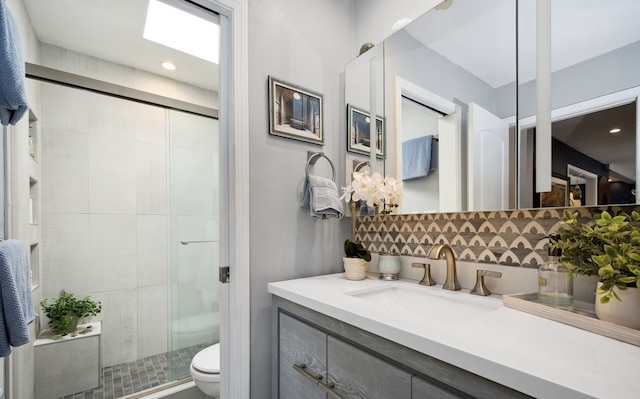 full bathroom with a stall shower, decorative backsplash, toilet, vanity, and recessed lighting