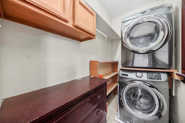 5019 N Kostner Ave, Chicago, IL 60630 - clothes washing area featuring stacked washer / dryer, cabinet space, and light tile patterned flooring
