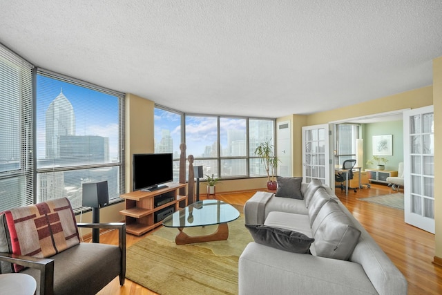 405 N Wabash Ave Unit 4709, Chicago, IL 60611 - living area featuring a textured ceiling, wood finished floors, and a wall of windows