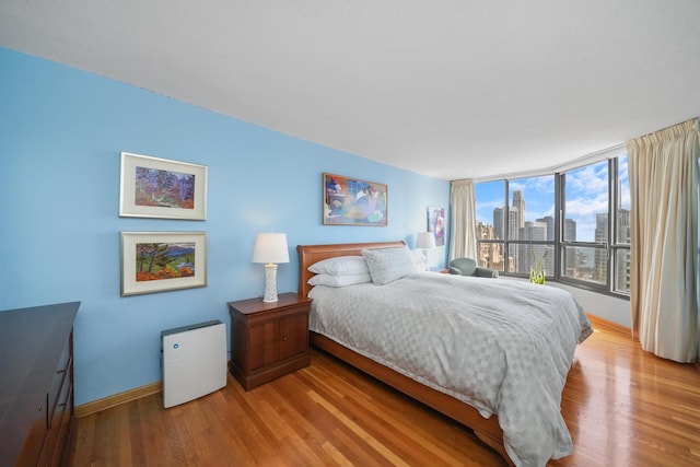 405 N Wabash Ave Unit 4709, Chicago, IL 60611 - bedroom with wood finished floors, a view of skyline, and baseboards