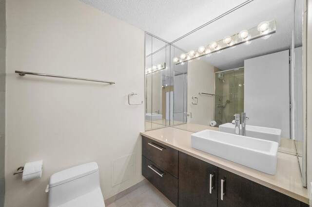 405 N Wabash Ave Unit 4709, Chicago, IL 60611 - bathroom with toilet, a shower with door, tile patterned flooring, vanity, and a textured ceiling