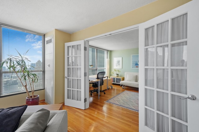 405 N Wabash Ave Unit 4709, Chicago, IL 60611 - doorway featuring french doors, an office area, wood finished floors, and a textured ceiling