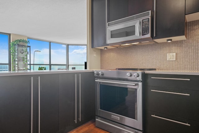 405 N Wabash Ave Unit 4709, Chicago, IL 60611 - kitchen featuring stainless steel appliances, tasteful backsplash, dark wood-style flooring, and light countertops
