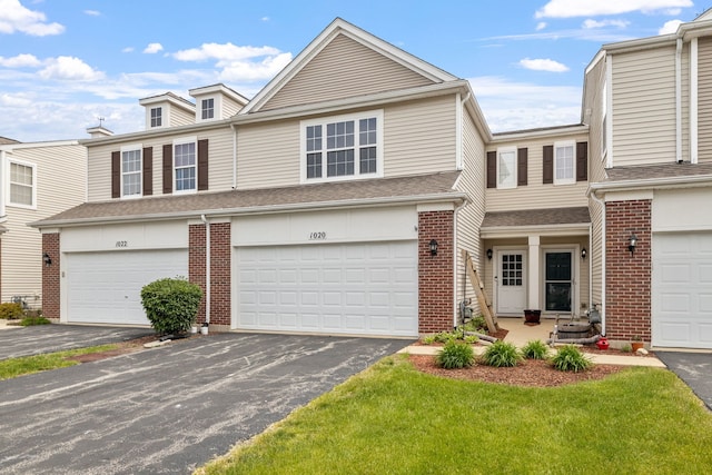 1020 Heron Cir, Joliet, IL 60431 - view of property featuring asphalt driveway, brick siding, and an attached garage