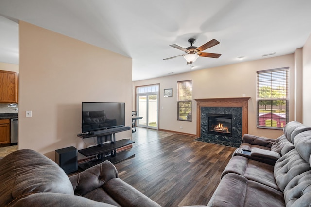 1020 Heron Cir, Joliet, IL 60431 - living area with dark wood-type flooring, healthy amount of natural light, a ceiling fan, and a fireplace