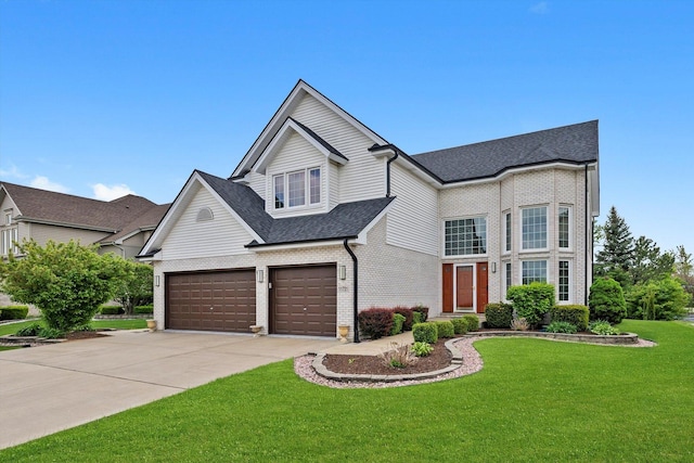 11731 Blackburn Dr, Orland Park, IL 60467 - view of front of house with driveway, brick siding, a shingled roof, a front lawn, and a garage