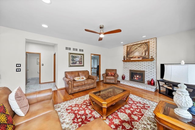 11731 Blackburn Dr, Orland Park, IL 60467 - living room featuring ceiling fan, a fireplace, wood finished floors, and recessed lighting