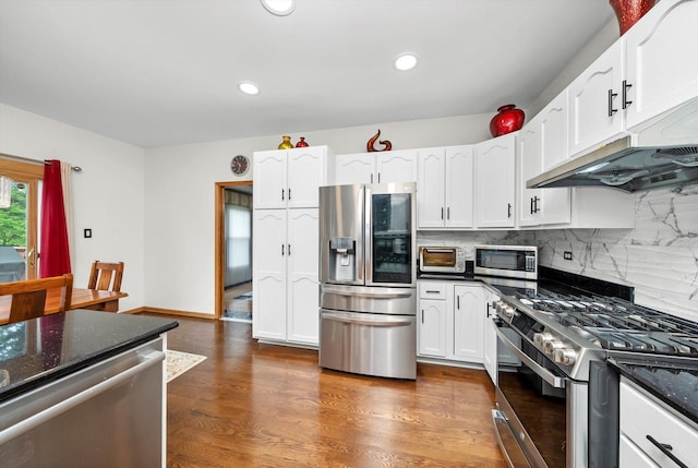 11731 Blackburn Dr, Orland Park, IL 60467 - kitchen featuring stainless steel appliances, white cabinets, decorative backsplash, dark stone countertops, and recessed lighting