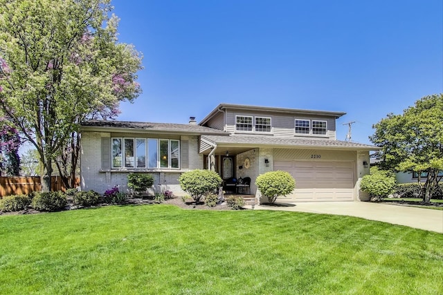 split level home with driveway, brick siding, and an attached garage