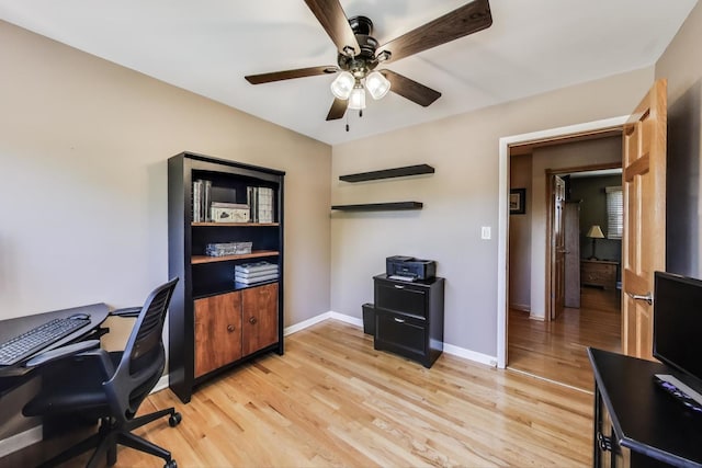 office area with a ceiling fan, light wood-style floors, and baseboards