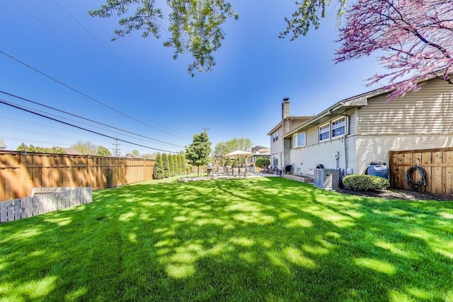 view of yard with cooling unit and a patio area