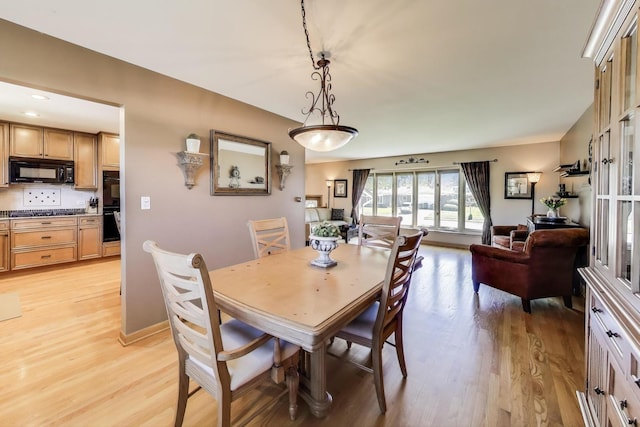 dining space featuring light wood-style flooring