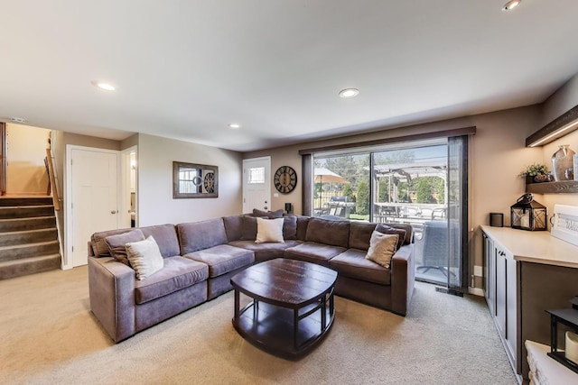 living area with light colored carpet, recessed lighting, and stairway