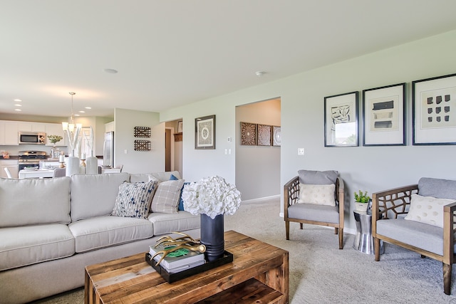 living area with light colored carpet, a chandelier, and baseboards