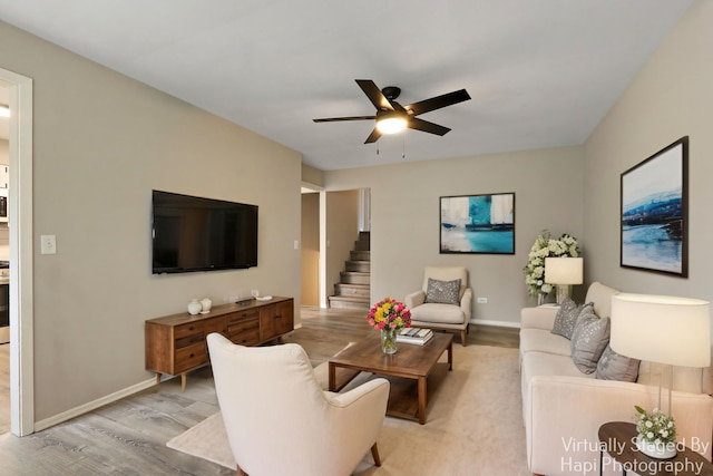 25269 W Anderson St, Ingleside, IL 60041 - living area featuring light wood-style floors, a ceiling fan, baseboards, and stairs