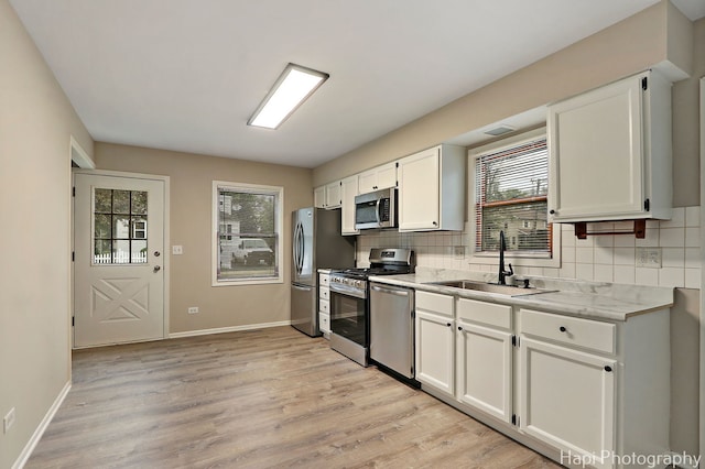 25269 W Anderson St, Ingleside, IL 60041 - kitchen featuring a sink, appliances with stainless steel finishes, tasteful backsplash, and white cabinets