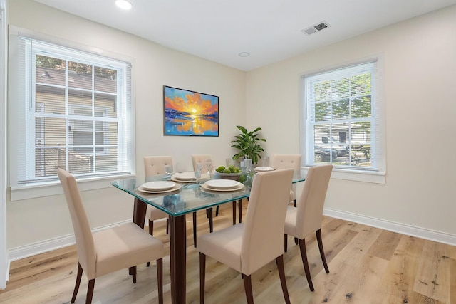 dining area with light wood-style flooring, baseboards, and recessed lighting