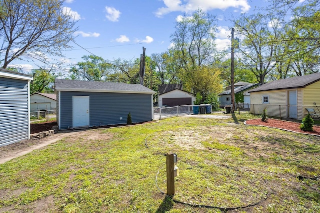 view of yard with an outdoor structure and a detached garage