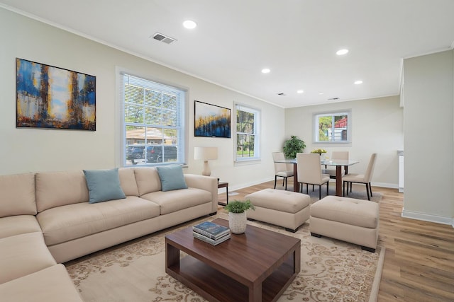 living area featuring ornamental molding, light wood-style flooring, recessed lighting, and baseboards