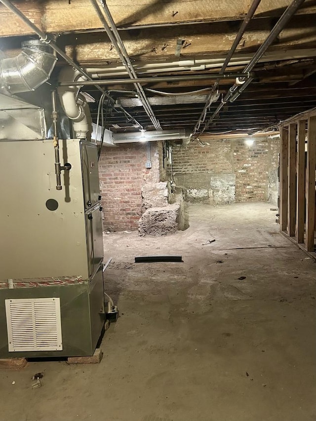 8105 S Muskegon Ave, Chicago, IL 60617 - unfinished basement featuring heating unit and brick wall