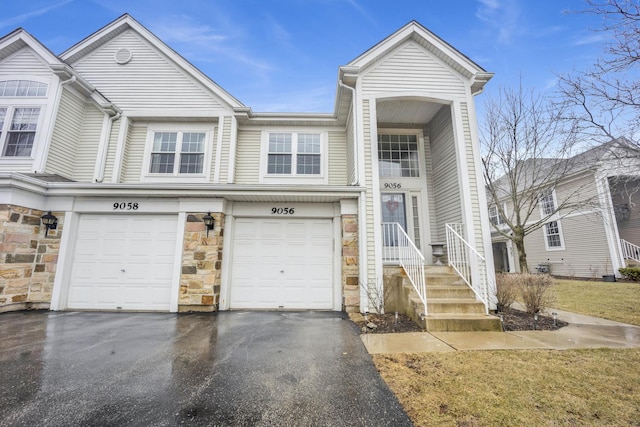 9056 W Heathwood Cir, Niles, IL 60714 - view of property featuring asphalt driveway, stone siding, and an attached garage