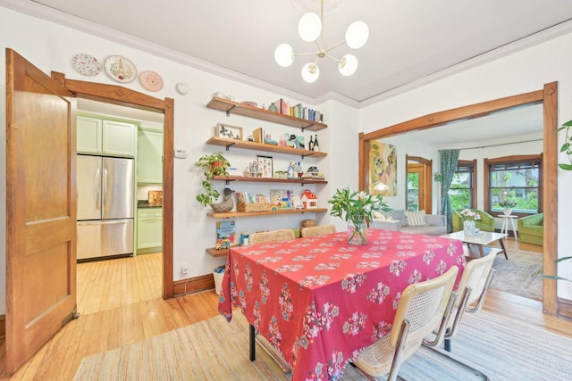 1031 S Humphrey Ave, Oak Park, IL 60304 - dining room with crown molding, light wood-style flooring, a chandelier, and baseboards