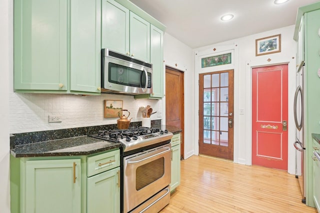 1031 S Humphrey Ave, Oak Park, IL 60304 - kitchen featuring stainless steel appliances, green cabinets, backsplash, light wood-type flooring, and recessed lighting