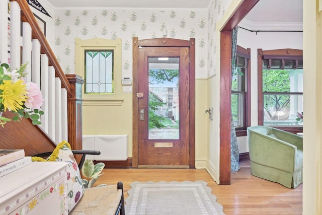 1031 S Humphrey Ave, Oak Park, IL 60304 - entrance foyer with wood finished floors, crown molding, wallpapered walls, stairway, and baseboards