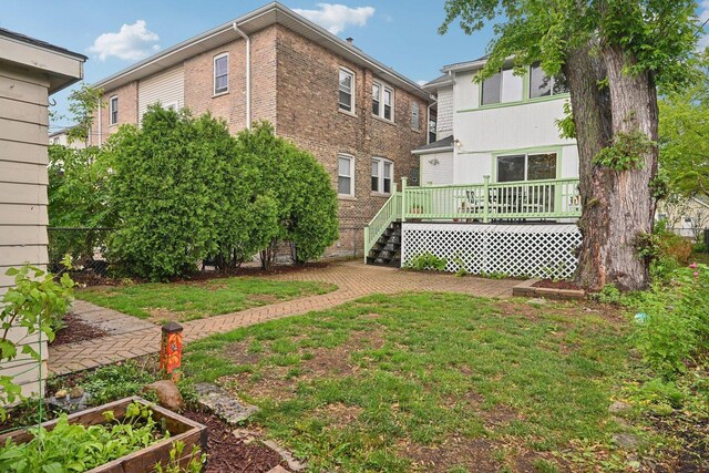 1031 S Humphrey Ave, Oak Park, IL 60304 - back of property with a deck, a lawn, and a garden