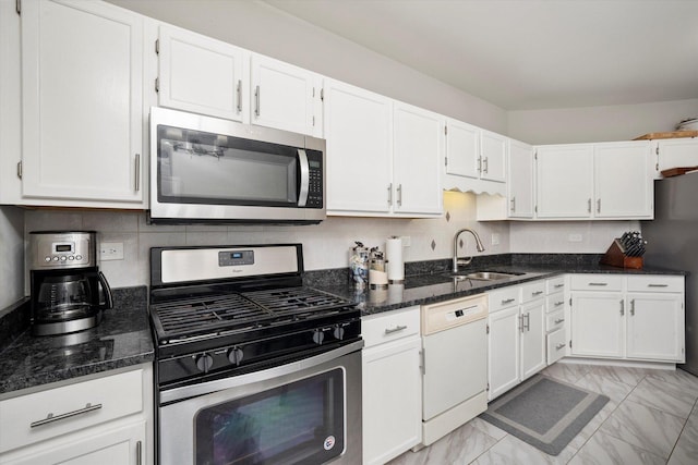 11001 Deblin Ln Unit 307, Oak Lawn, IL 60453 - kitchen with appliances with stainless steel finishes, a sink, light marble finish flooring, white cabinets, and dark stone countertops