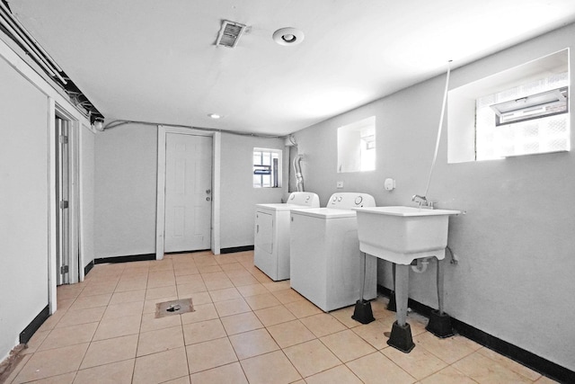 6409 S Champlain Ave, Chicago, IL 60637 - laundry area featuring separate washer and dryer, light tile patterned flooring, recessed lighting, and baseboards