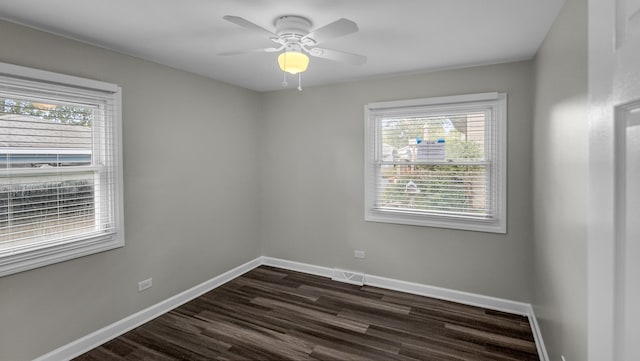 unfurnished room featuring dark wood-type flooring, baseboards, and ceiling fan