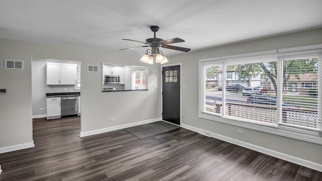 foyer entrance featuring dark wood finished floors, baseboards, and ceiling fan