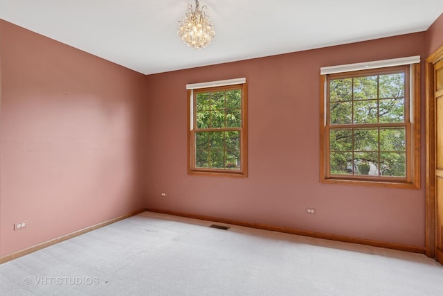 341 Breckenridge Dr, Aurora, IL 60504 - unfurnished room featuring baseboards, a chandelier, and light colored carpet