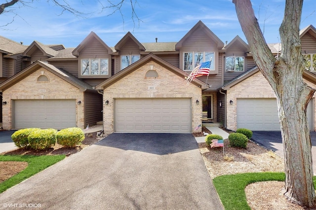805 Millcreek Cir, Elgin, IL 60123 - view of property with asphalt driveway and brick siding