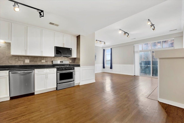 1910 S State St Unit 231, Chicago, IL 60616 - kitchen with stainless steel appliances, track lighting, open floor plan, dark countertops, and wainscoting