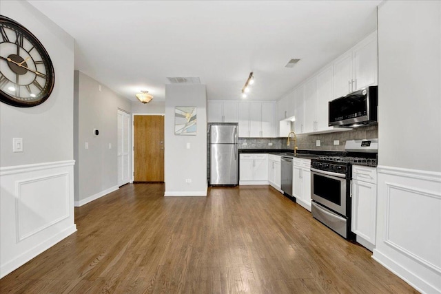 1910 S State St Unit 231, Chicago, IL 60616 - kitchen featuring appliances with stainless steel finishes, dark countertops, dark wood finished floors, and decorative backsplash