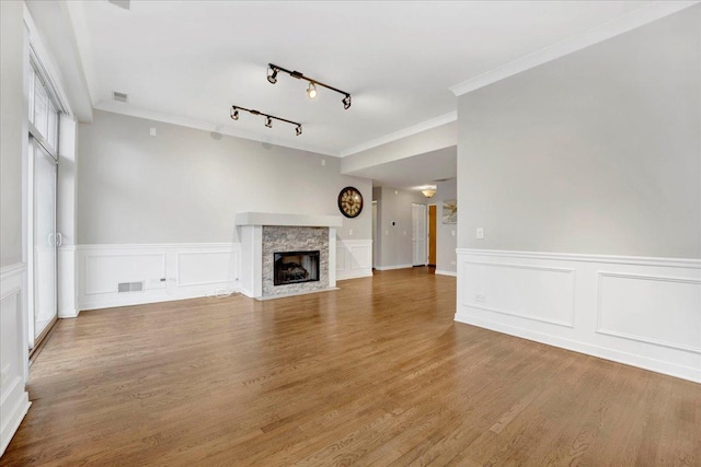1910 S State St Unit 231, Chicago, IL 60616 - unfurnished living room featuring ornamental molding, a decorative wall, track lighting, a fireplace, and wood finished floors