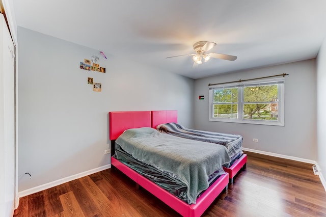 bedroom with baseboards, wood finished floors, and a ceiling fan