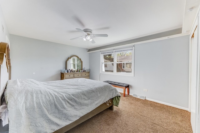 carpeted bedroom featuring baseboards and ceiling fan
