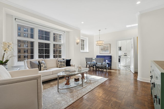 living room with baseboards, ornamental molding, and recessed lighting